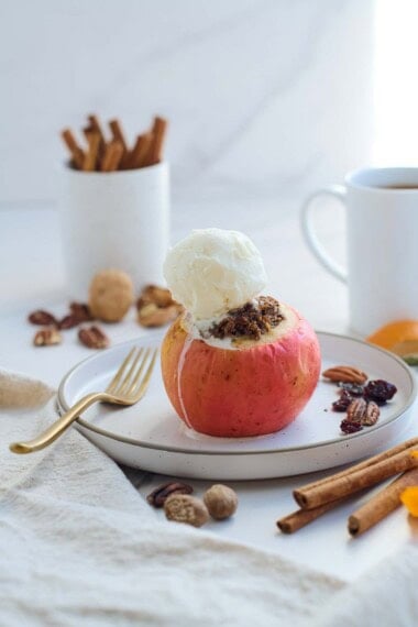 These Baked Apples are a cozy, fall dessert (or delicious homey breakfast!) Filled with toasted nuts and dates, dried cherries, cinnamon, and orange zest, they are maple-sweetened with no refined sugar! This baked apples recipe is vegan and gluten-free.