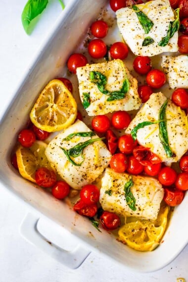 This delicious baked cod recipe features burst tomatoes, basil, garlic, and lemon. It can be made in 30 minutes flat-fast and easy!