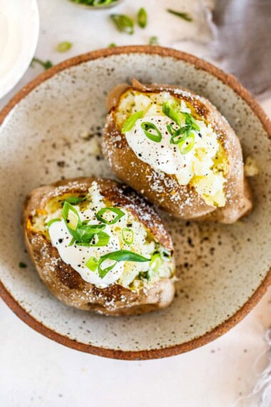 Learn how to bake a potato like a pro! This easy baked potato recipe yields perfectly fluffy insides with a deliciously crispy skin. All you need are russet potatoes, salt, and olive oil-and the olive oil is optional too.