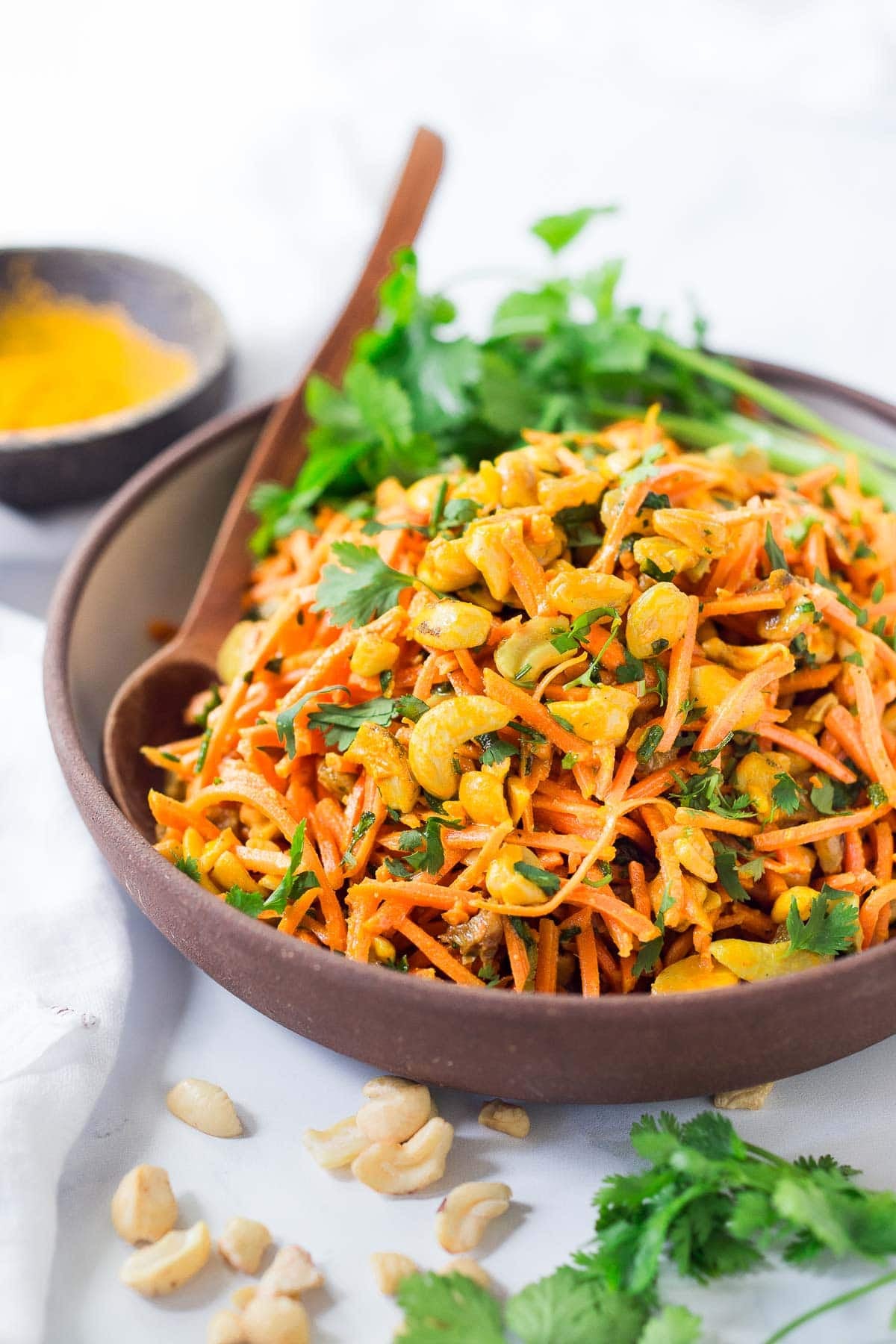 Fresh and flavorful, this carrot salad recipe is infused with Indian flavor! Studded with toasted cashews and raisins, fresh grated carrots are tossed in a delicious Indian curry dressing. Easy, healthy, vegan, and perfect for gatherings!