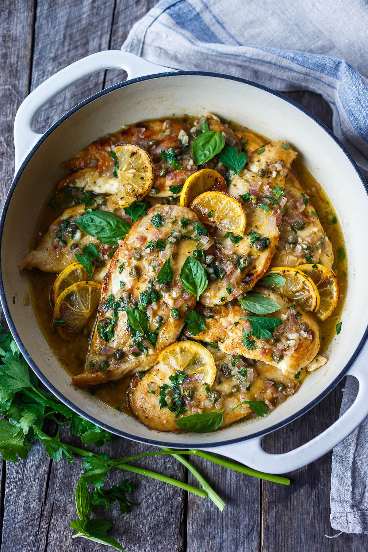 Chicken Piccata in a pan with lemon, capers, herbs, and no cream. 