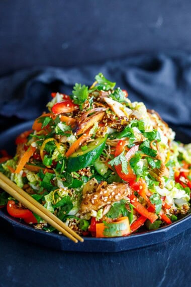 This Chinese Chicken Salad recipe is made with crisp napa cabbage, sesame chicken, crunchy veggies, fresh herbs, and the best dressing ever, topped with sesame almond brittle. Vegan-adaptable.