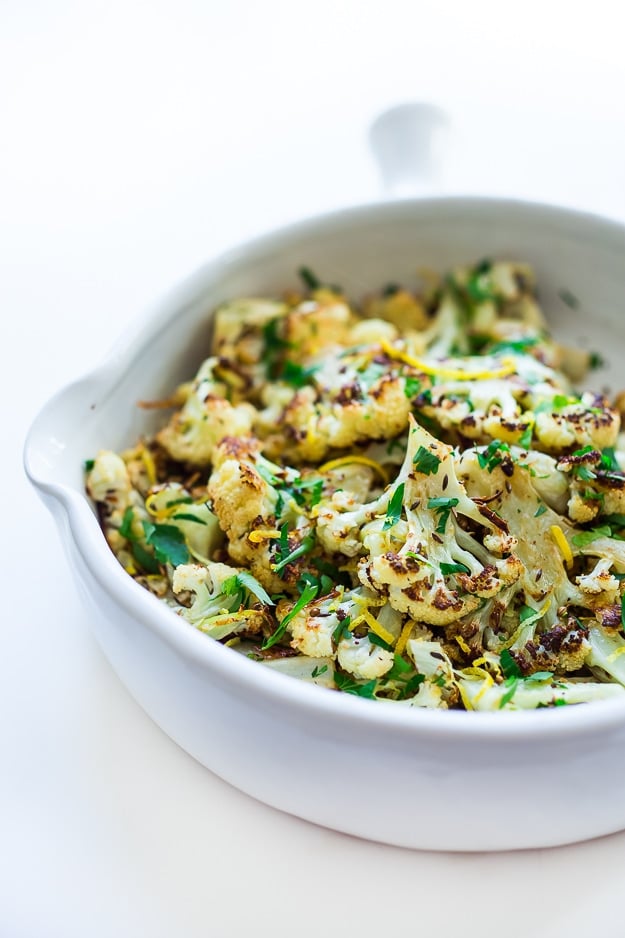 serving dish with roasted cauliflower with parsley and lemon zest.