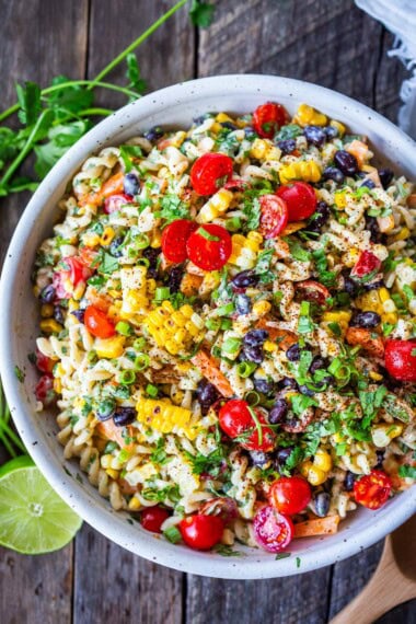 Southwest Pasta Salad is so satisfying with just the right amount of zesty kick. Tender pasta, crunchy fresh veggies, corn, and black beans dressed with a delicious Chipotle Ranch Dressing. The perfect side dish for potlucks, cookouts, and BBQS.