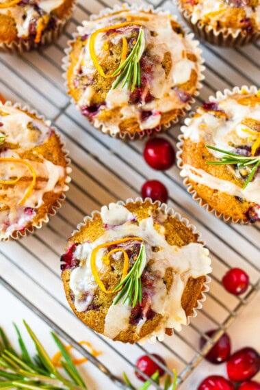 These festive Cranberry Orange Muffins are bursting with bright citrus flavor, juicy tart cranberries, and a hint of rosemary. Vegan and gluten-free
