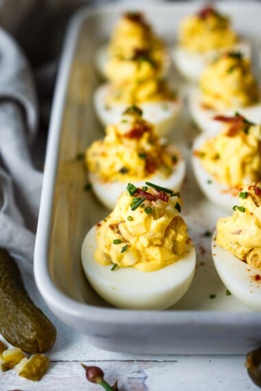 These deviled eggs have the best texture and flavor! Studded with crispy bacon (or vegan bacon), cheddar cheese, diced pickles, and sweet onions, they are creamy with delicious flavor. 
