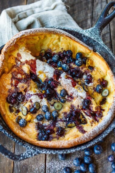 Delicious and impressive Blueberry Dutch Baby is made with everyday pantry ingredients and requires only about 10 minutes of hands-on time! Top with maple-sweetened blueberry sauce for a perfect brunch or dessert.