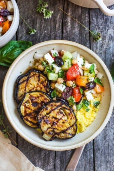 Grilled Eggplant with fresh Greek relish and creamy polenta.  An easy and healthy meatless dinner.  Vegan adaptable and gluten-free.