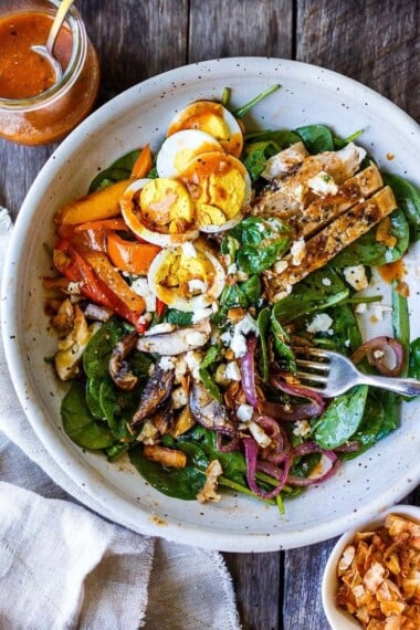 This Grilled Chicken Salad is deeply flavored with grilled mushrooms, red onions, sweet peppers, and baby spinach, tossed with our healthy take on a flavorful French dressing. Perfect for weeknights or entertaining!  