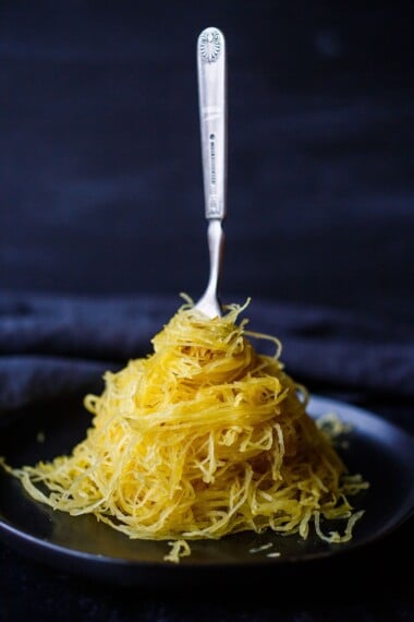 Learn How to Cook Spaghetti Squash -a faster method for roasted Spaghetti Squash that yields long spaghetti-like strands with better texture.