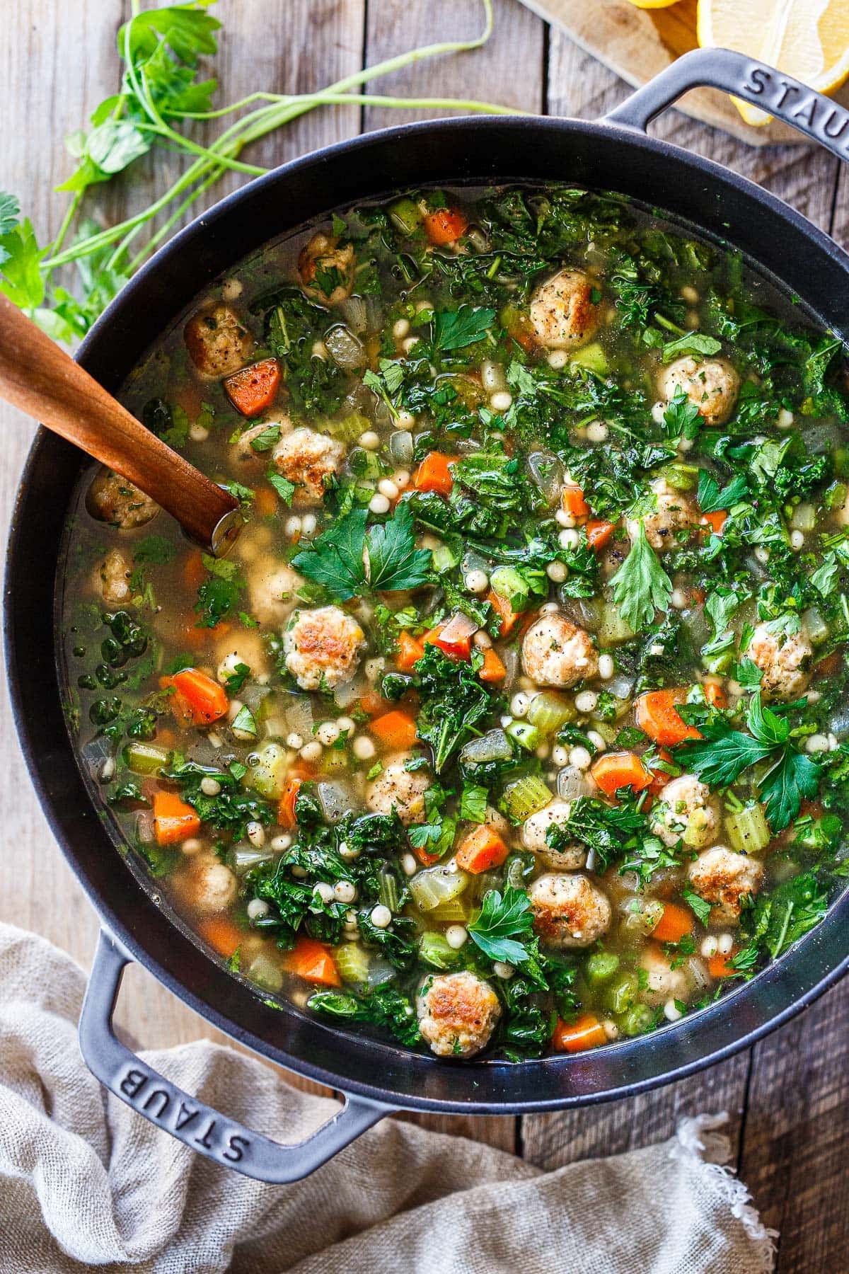 Dutch oven with Italian Wedding soup with a wood spoon, 