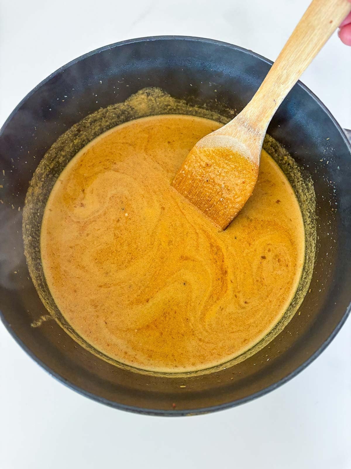Making the flavorful coconut broth.
