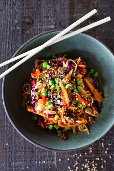 Here's a super tasty recipe for Vegan Kimchi Noodles, stir-fried with lots of healthy veggies you probably have on hand. Keep it vegan or add an egg, chicken or shrimp! Crispy tofu is also a delicious option here! #kimchi #kimchinoodles #kimchirecipes #vegannoodles