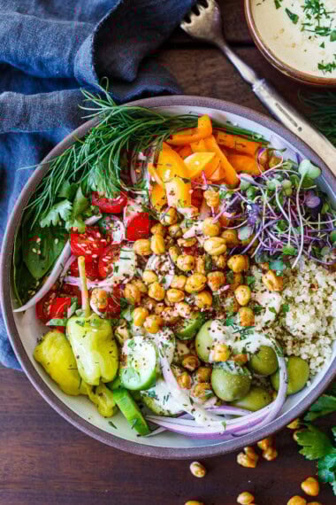 These Mediterranean Chickpea Bowls are loaded with crispy chickpeas, quinoa, fresh veggies, and a creamy tahini sauce. A vibrant, high-protein vegan meal that's perfect for lunch, dinner, or meal prep.