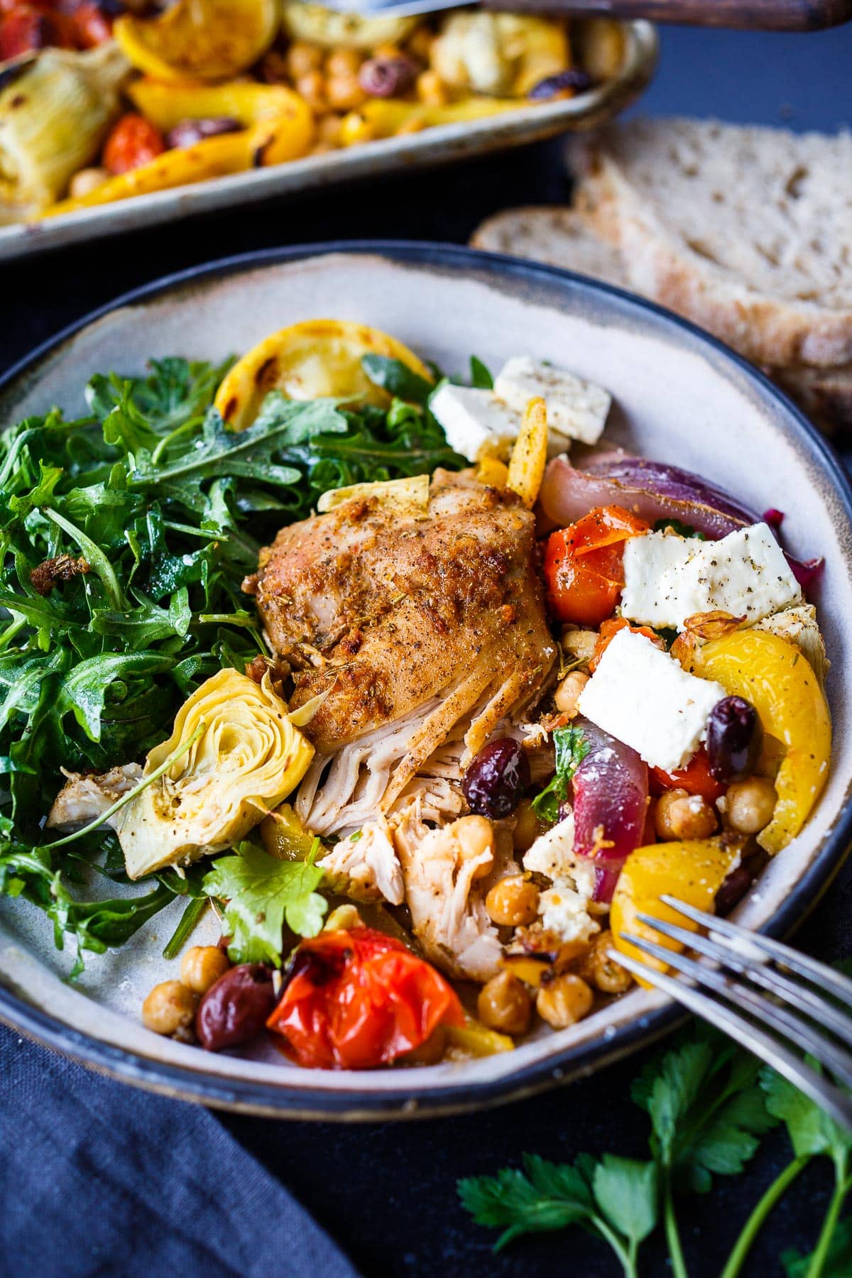 Mediterranean Chicken with veggies, chickpeas, olives and herbs. A delicious Sheet Pan Dinner.