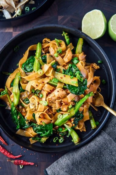 Learn how to make easy, authentic Pad See Ew with stir-fried rice noodles, Chinese broccoli, and a deep and smoky Pad See Ew sauce. Choose your protein (tofu, chicken, or shrimp) and make this in under 30 minutes for a quick, easy weeknight dinner.
