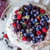 Pavlova with fresh berries and lofty whip cream. A light and airy dessert perfect for celebrations and gatherings. With a little planning ahead, this is easier than you may think!  