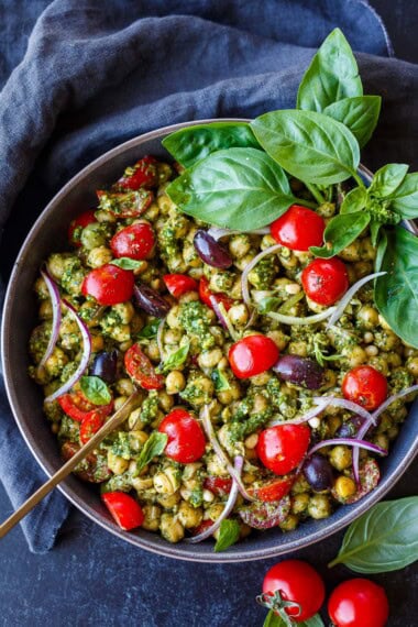 Here is one of our favorite chickpea recipes, perfect for dinner or lunch! Creamy warm chickpeas tossed with pesto, kalamata olives, cherry tomatoes, red onion, sprinkled with Parmesan. Easy to make in 20 mins!