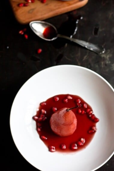 These festive red wine Poached Pears are absolutely gorgeous, infused with beautiful color! This light and healthy dessert is perfect for the holidays- vegan and can be made ahead. 