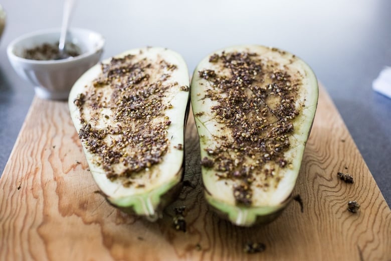 za'atar seasoning spread over eggplant halves. 