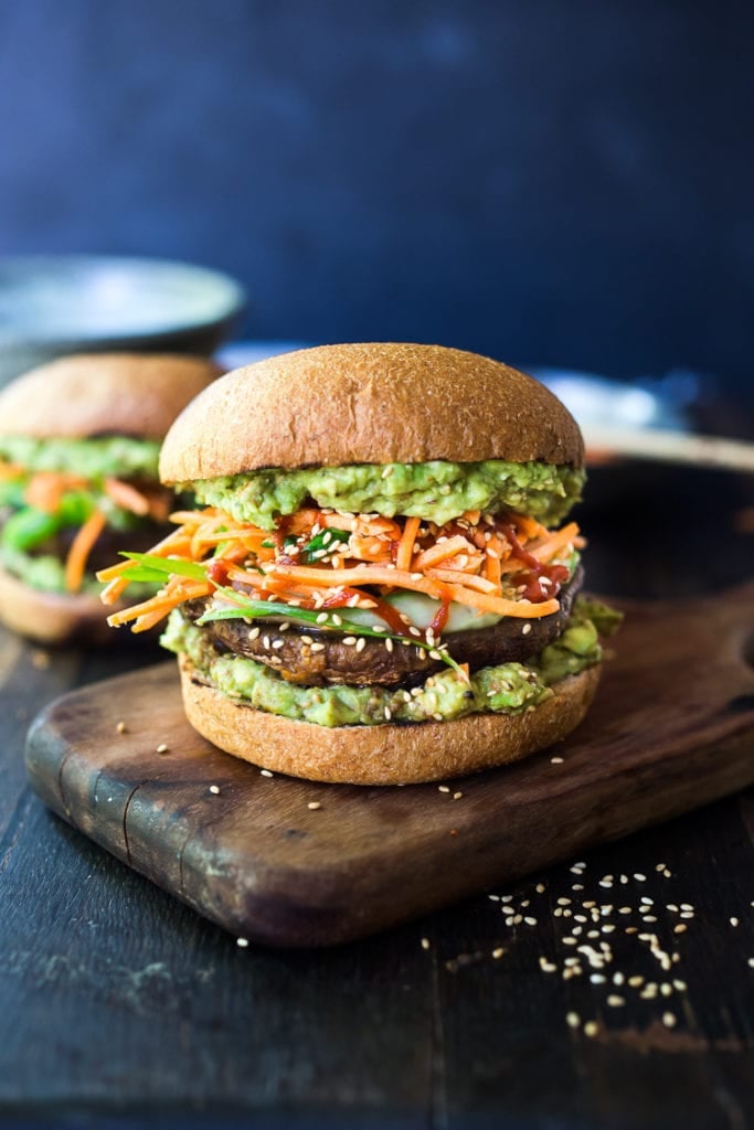 portobello mushroom burger with Asian-style guacamole, shredded carrots, sesame seeds.