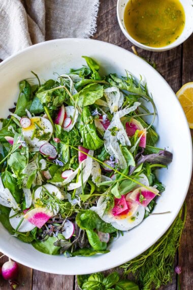 Simple, herby, and delicious, this spring salad recipe is made with tender spring greens, fresh herbs, shaved fennel, and radishes tossed in a lemon dressing