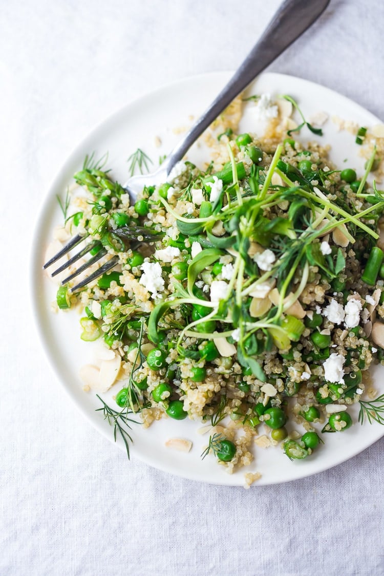 A simple recipe for Quinoa Asparagus Salad ( aka Spring Tabouli) tossed with English peas,  fresh dill, parsley, toasted almonds in a lemony dressing topped with optional avocado, goat or feta cheese. A healthy, flavorful salad that can be made ahead- perfect for special gatherings or midweek lunches! GF &  Vegan adaptable! 