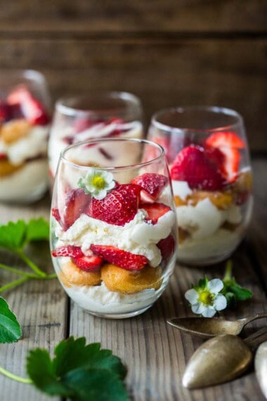 This strawberry tiramisu recipe is the perfect spring dessert. Fresh strawberries are layered with lady fingers soaked in orange juice and St. Germaine (elderflower liqueur) with a whipped mascarpone-yogurt cream. Light and refreshing, this one is a crowd pleaser.