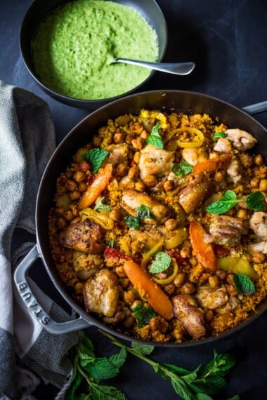 A delicious Tunisian-inspired Chicken Tagine (or sub chickpeas) with couscous, carrots, and flavorful Green Harissa Sauce. A one-pan meal that can be made in 45 minutes! Vegan and Gluten-free adaptable!