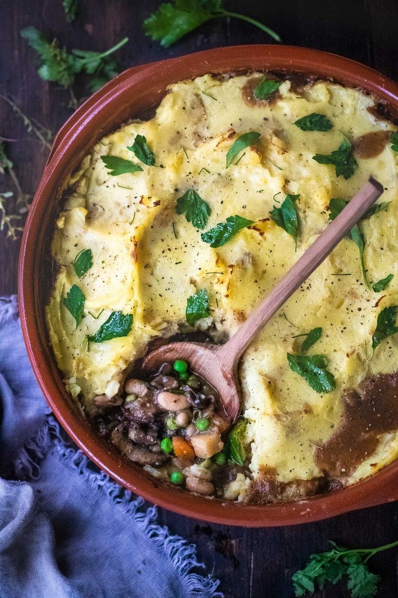 Vegan Shepherds Pie with mushrooms and root vegetables- topped with pillowy mashed potatoes. A delicious vegan main dish -perfect for the holiday table. #sheperdspie #vegan
